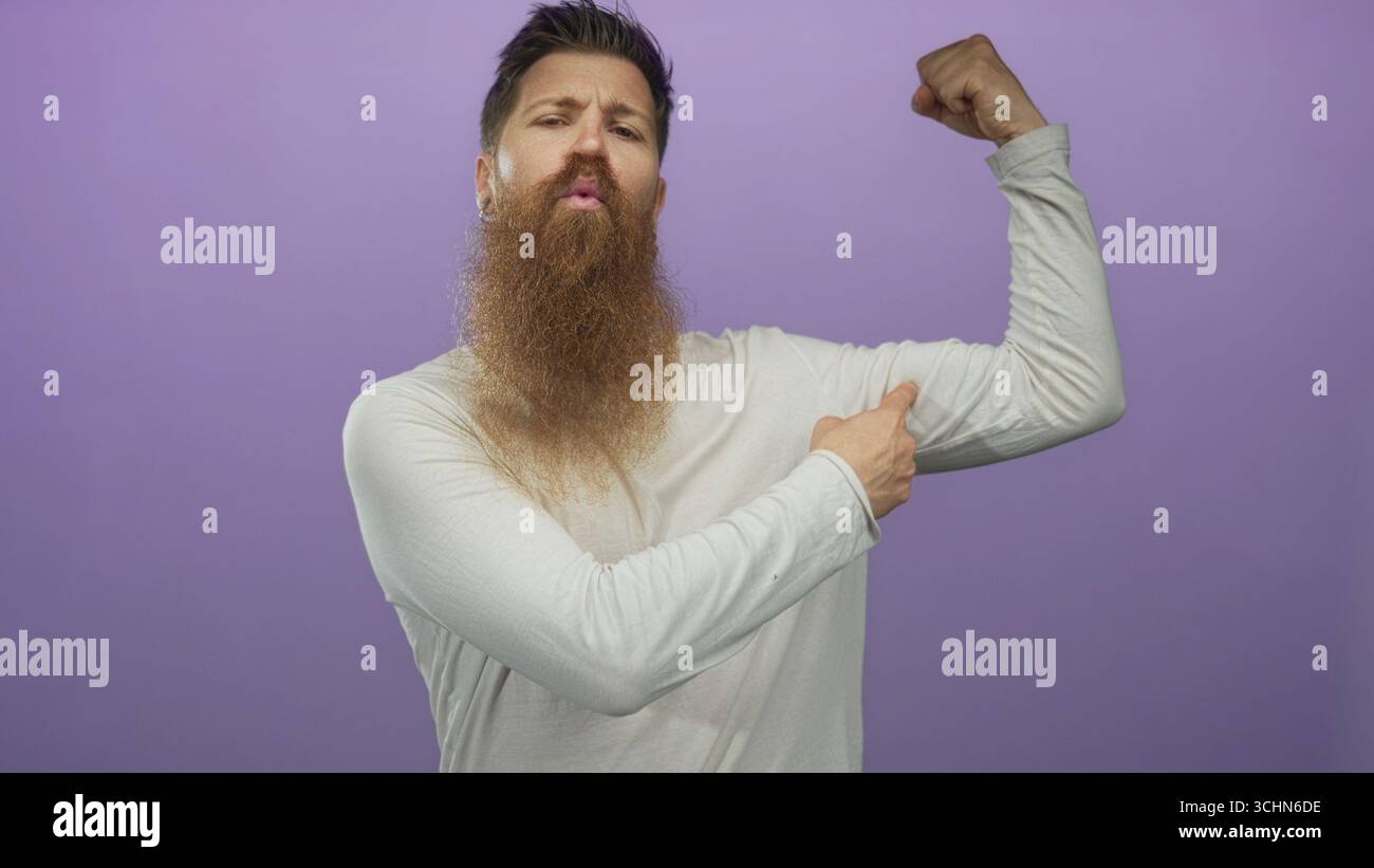 Finger Biceps Man flexes bicep muscle in studio with index finger pointing to peak ...