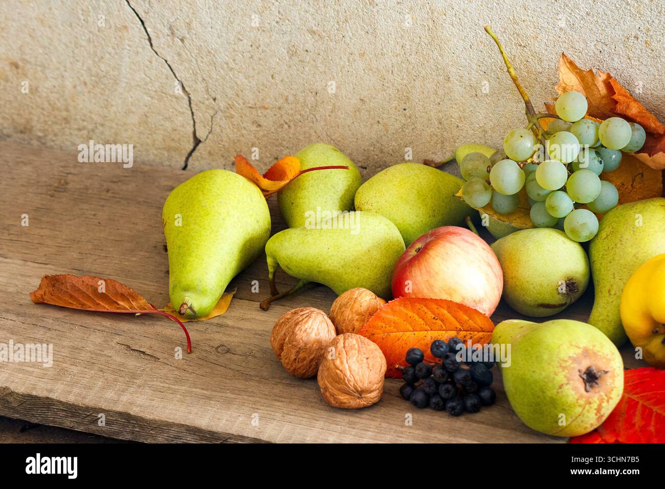 variety of ripe fruits on the wood. autumn harvest rustic composition. rural organic food in fall season. applicable as thanksgiving background Stock Photo