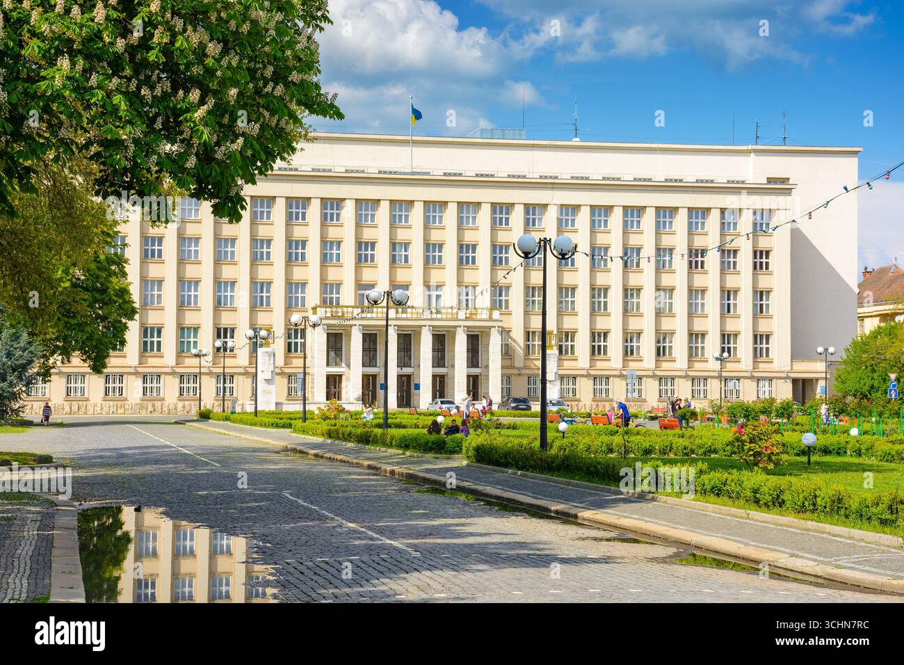 uzhhorod, ukraine - 06 may, 2017: government building of zakarpattia state administration. czechoslovakia architecture and cobblestone street of trans Stock Photo