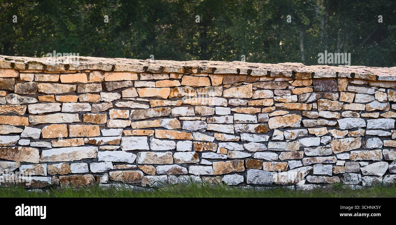 Panoramic rustic stone wall, seamless masonry texture ideal as natural background, architecture pattern or design surface. Stock Photo