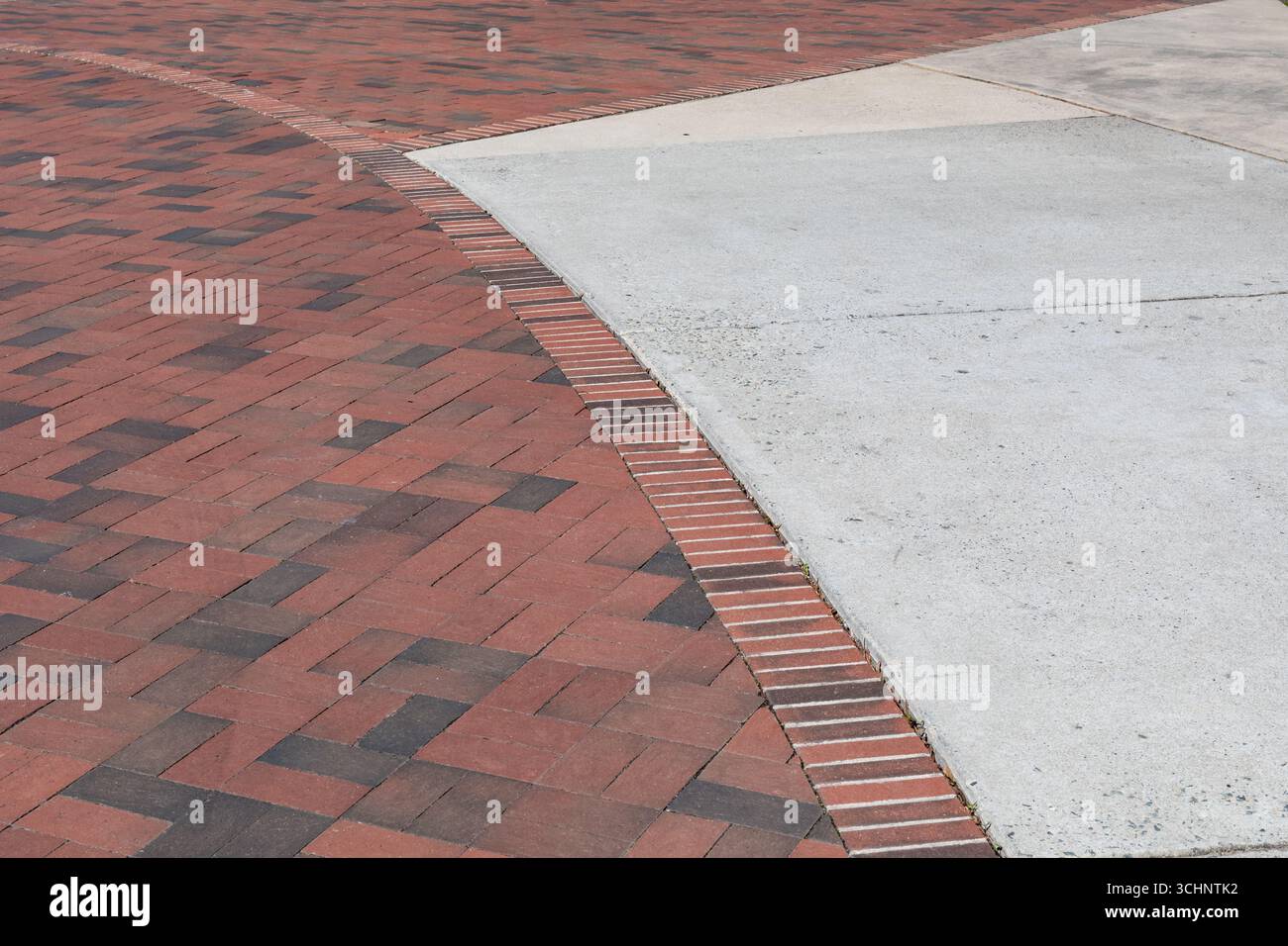 Intersection of brick paths with concrete pads, sweeping curve creative copy space, horizontal aspect Stock Photo
