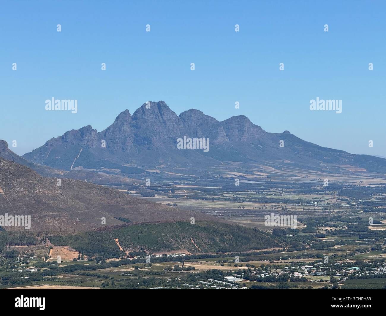 A wide-angle shot of the mountain range overlooking the town of Stellenbosch, South Africa. - Smartphone Captured Stock Image