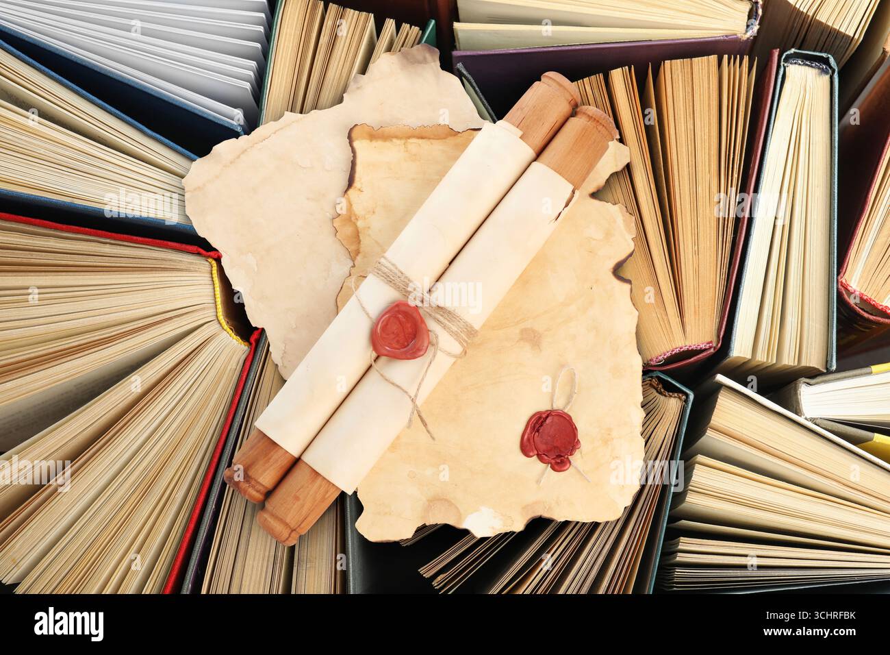 Sheets and scroll of old paper on books, top view Stock Photo - Alamy