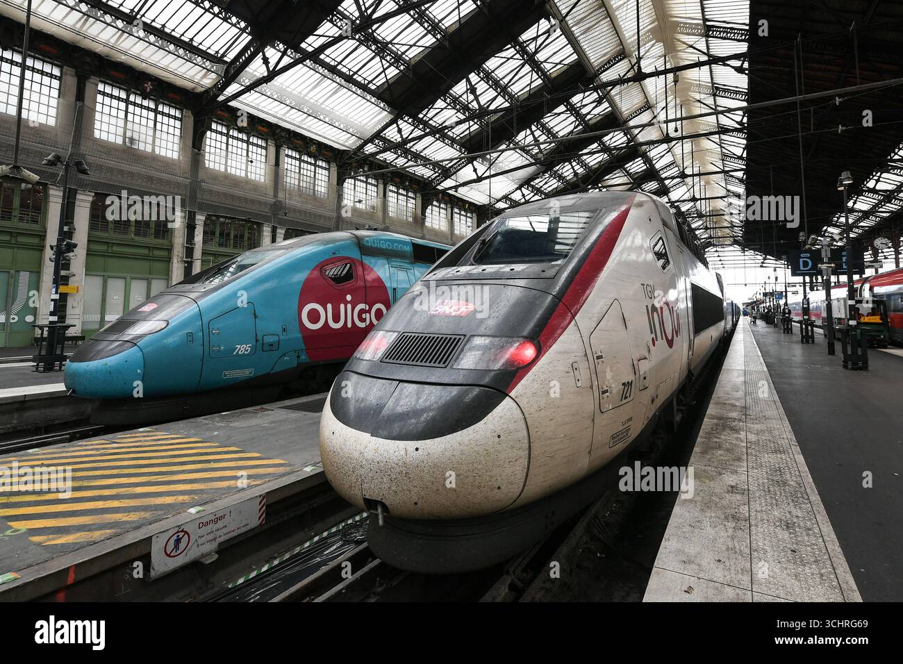This photograph shows a SNCF OUIGO train stationed near a SNCF inOui ...