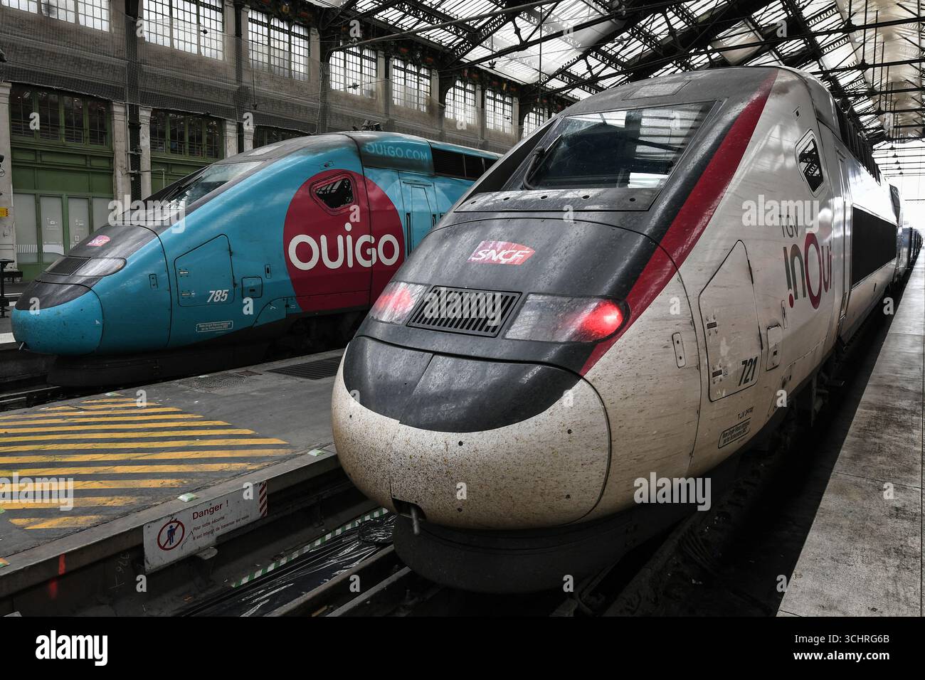 This photograph shows a SNCF OUIGO train stationed near a SNCF inOui ...