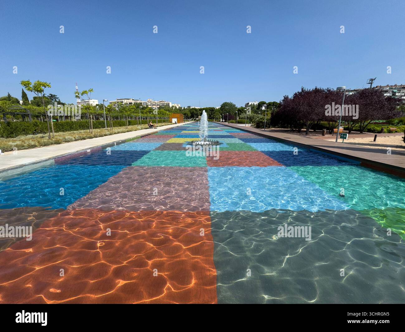 Polychrome Pond: A pond with a colorful tiled base, surrounded by a series of fountains. Tercer Depósito Park, Parque. Chamberi, Madrid - Smartphone Captured Stock Image