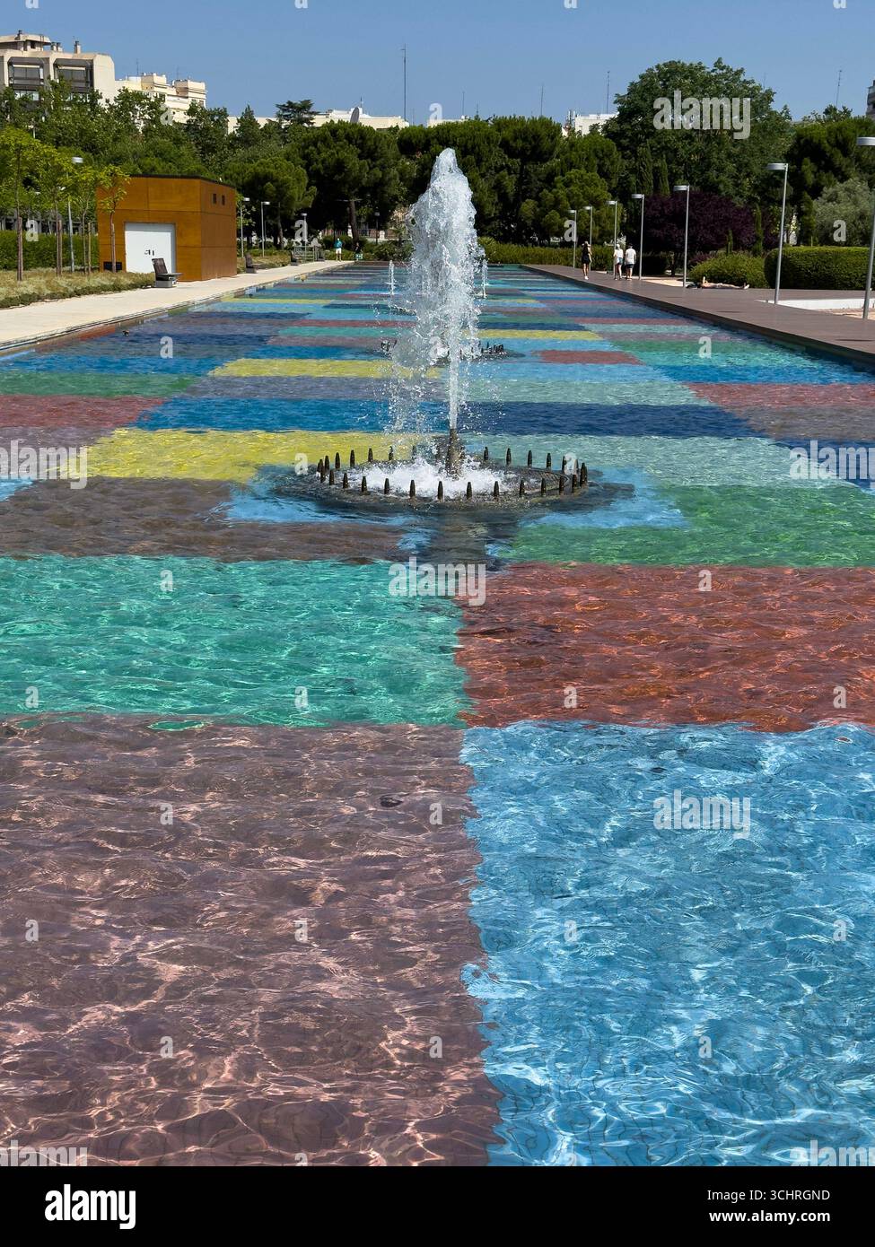 Polychrome Pond: A pond with a colorful tiled base, surrounded by a series of fountains. Tercer Depósito Park, Parque. Chamberi, Madrid - Smartphone Captured Stock Image