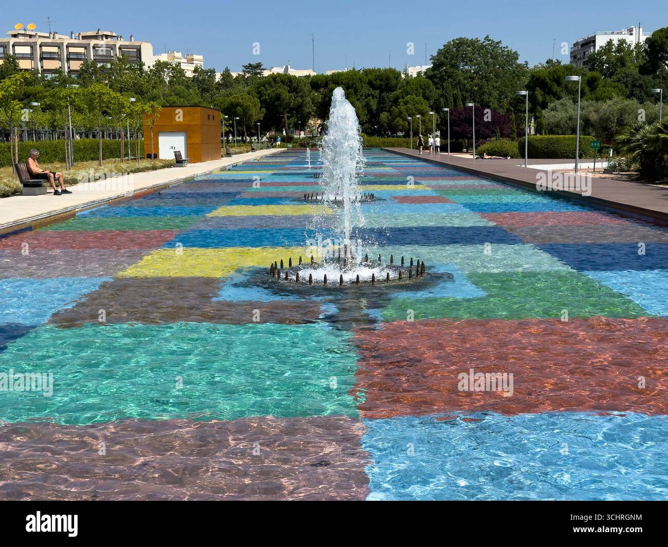 Polychrome Pond: A pond with a colorful tiled base, surrounded by a series of fountains. Tercer Depósito Park, Parque. Chamberi, Madrid - Smartphone Captured Stock Image