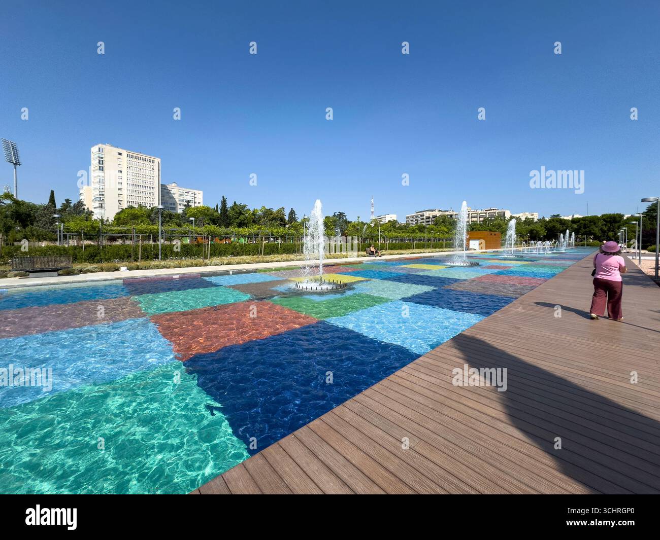 Polychrome Pond: A pond with a colorful tiled base, surrounded by a series of fountains. Tercer Depósito Park, Parque. Chamberi, Madrid - Smartphone Captured Stock Image