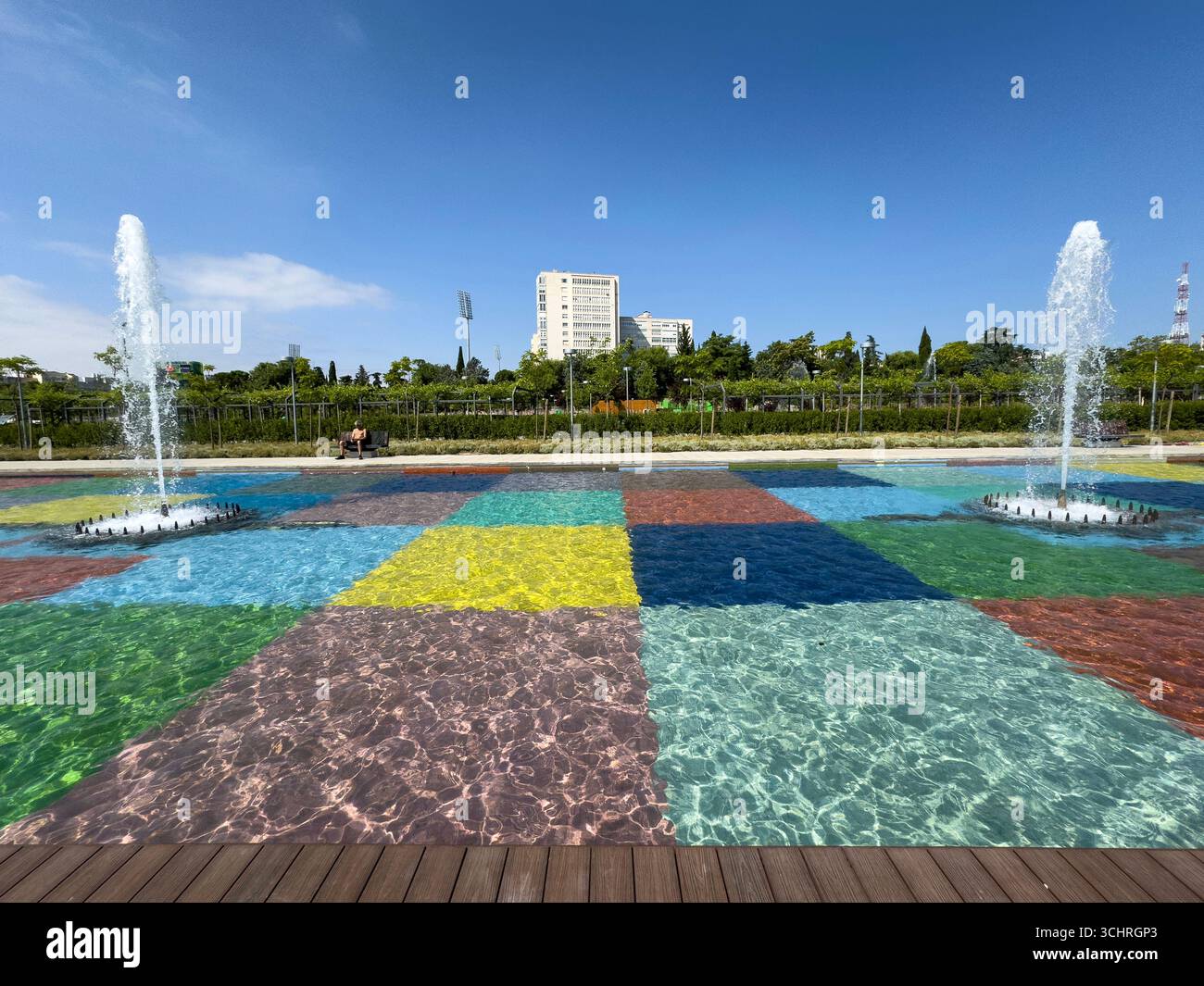 Polychrome Pond: A pond with a colorful tiled base, surrounded by a series of fountains. Tercer Depósito Park, Parque. Chamberi, Madrid - Smartphone Captured Stock Image
