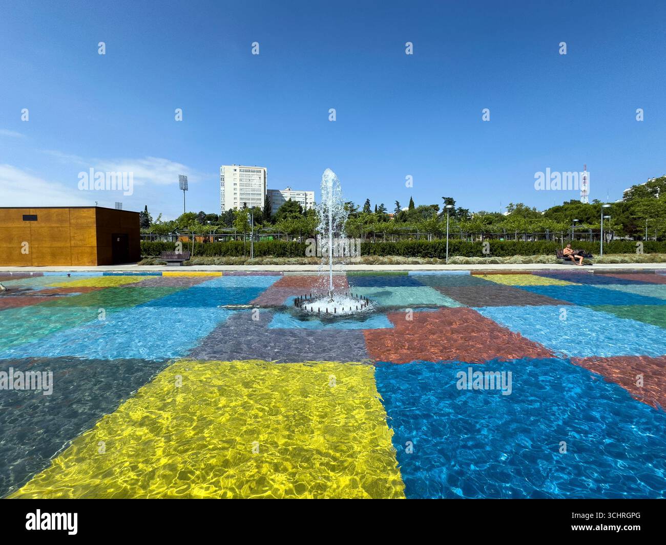 Polychrome Pond: A pond with a colorful tiled base, surrounded by a series of fountains. Tercer Depósito Park, Parque. Chamberi, Madrid - Smartphone Captured Stock Image