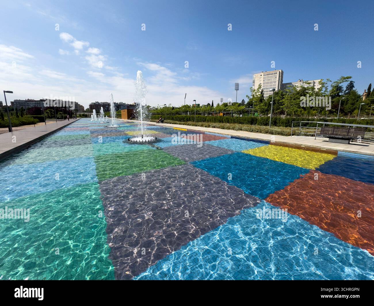 Polychrome Pond: A pond with a colorful tiled base, surrounded by a series of fountains. Tercer Depósito Park, Parque. Chamberi, Madrid - Smartphone Captured Stock Image