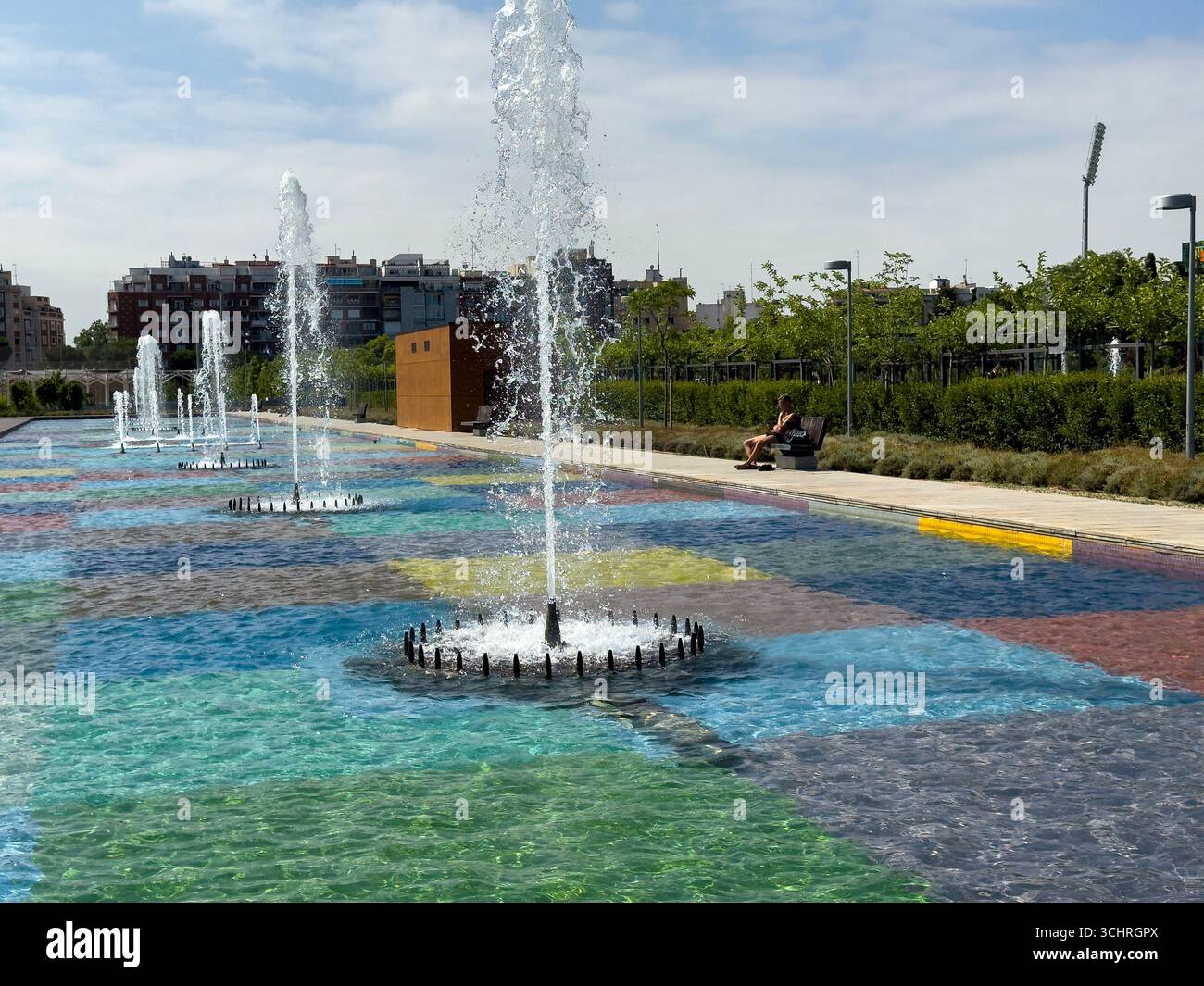 Polychrome Pond: A pond with a colorful tiled base, surrounded by a series of fountains. Tercer Depósito Park, Parque. Chamberi, Madrid - Smartphone Captured Stock Image