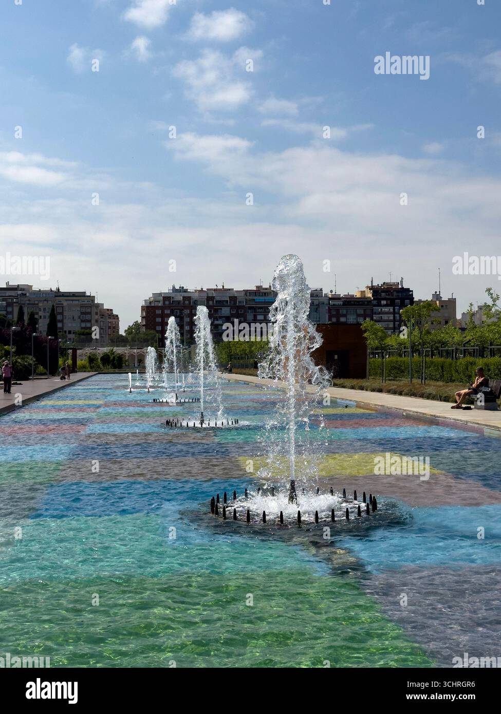 Polychrome Pond: A pond with a colorful tiled base, surrounded by a series of fountains. Tercer Depósito Park, Parque. Chamberi, Madrid - Smartphone Captured Stock Image