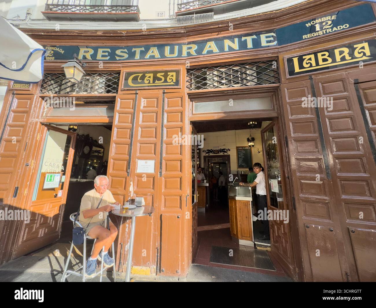 Established in 1860, Casa Labra is a historic tavern located at Calle de Tetuán, 12, just steps from Puerta del Sol in central Madrid, Spain - Smartphone Captured Stock Image