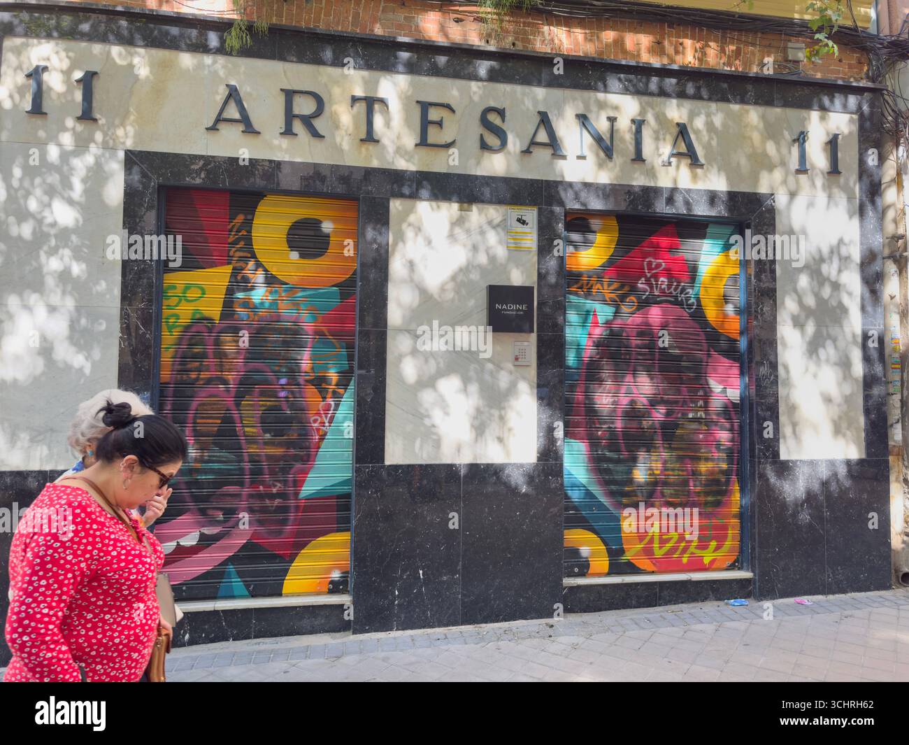 Artesania, Nadine fundacion, with painted by NIH graffiti in 11 calle Galileo, Chamberi, Madrid, Spain - Smartphone Captured Stock Image