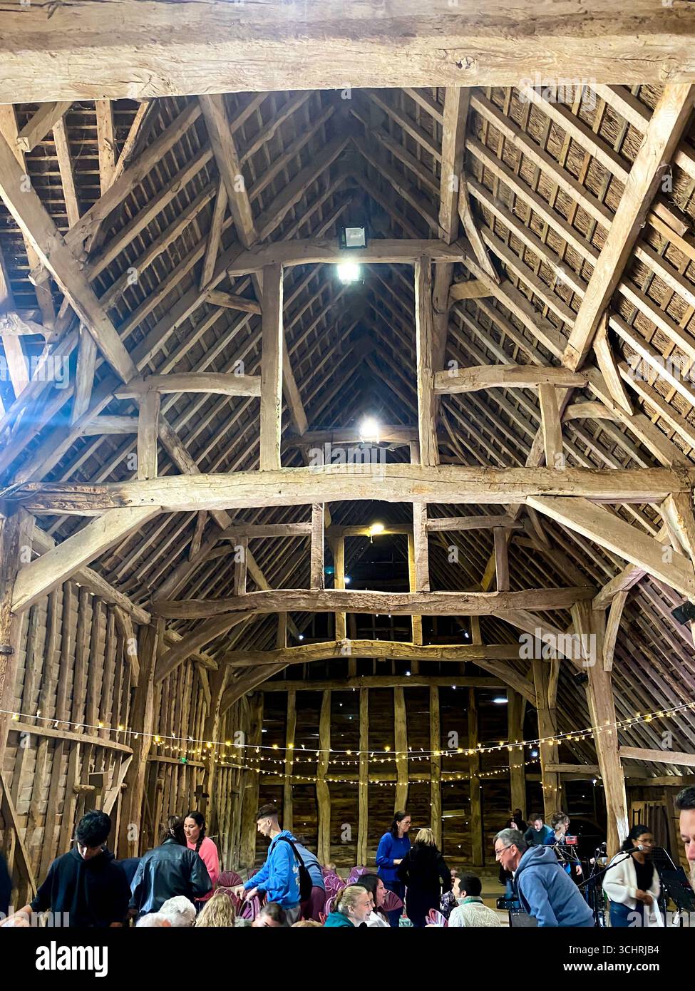 Inside an old barn with a wooden structure, a space for hosting events. - Smartphone Captured Stock Image