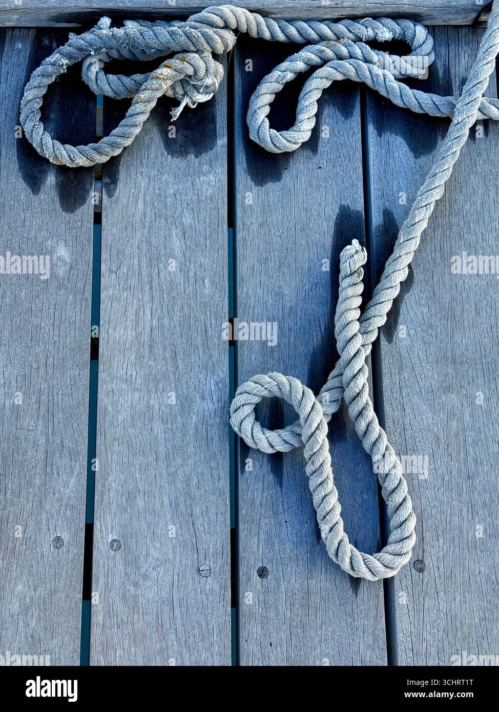 The pier and rope are a symbol of sea travel. - Smartphone Captured Stock Image