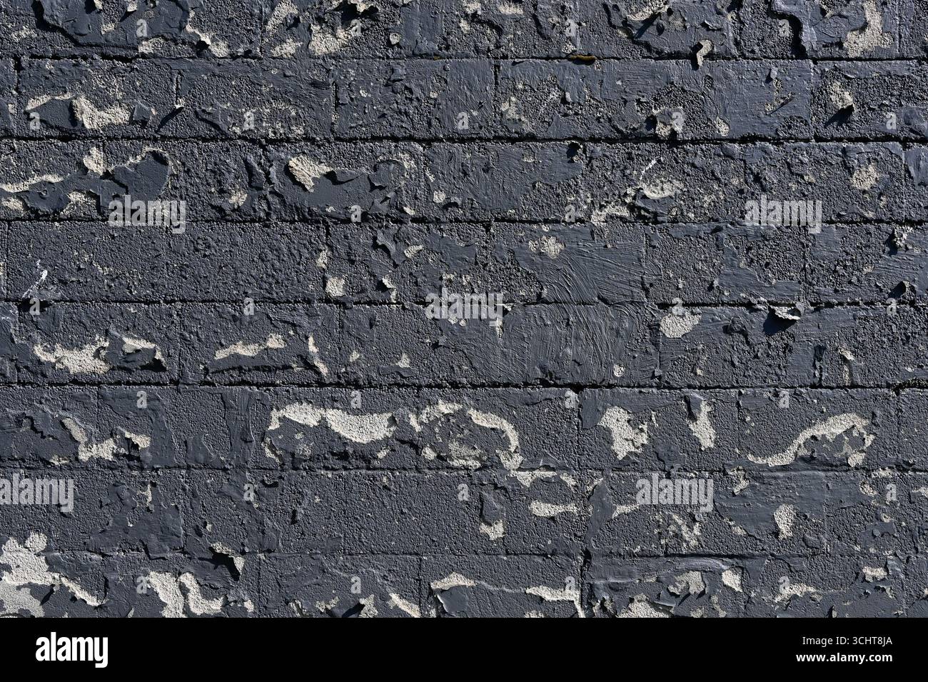 Peeling paint on a old brick wall for use as a background texture Stock Photo