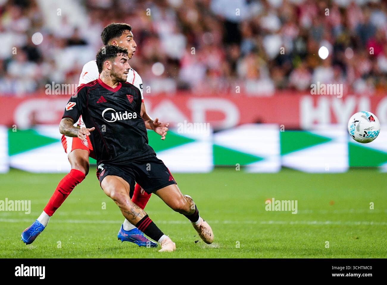 Isaac Romero of Sevilla FC and Vitor Reis of Girona FC during the La ...