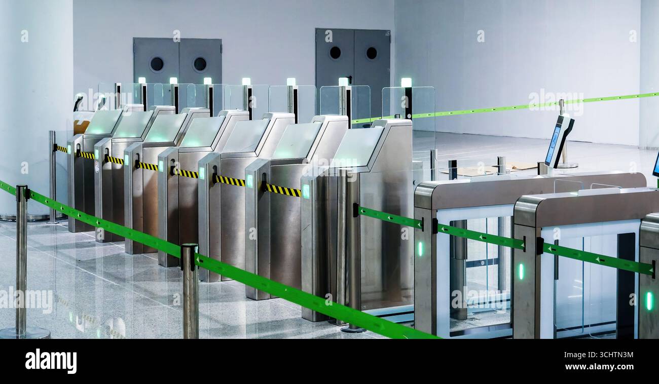 Modern automated passport control gates with glass barriers, scanners ...