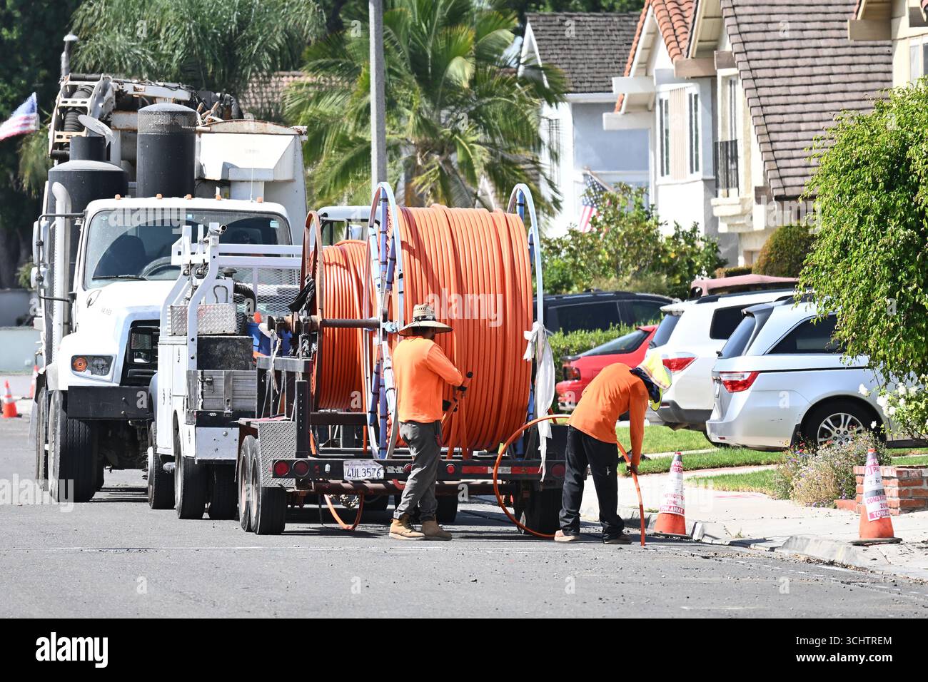 IRIVNE, CALIFORNIA - 09 SEPT 2025: Workers laying Fiber Optic Cable for Cityside Fiber in a residential community. Stock Photo