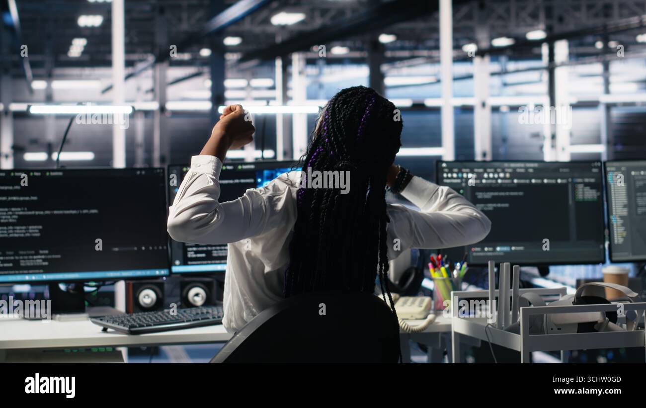 Data center manager checking work done by admins using deep learning to analyze datasets. Server hub supervisor overseeing IT specialists using AI neural networks to recognize data patterns, camera A Stock Photo