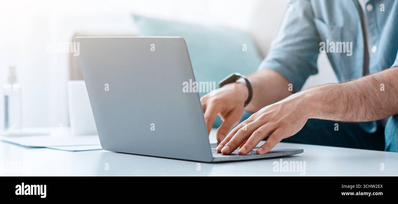 Unrecognizable bearded man working on pc, typing text or programming code on computer keyboard Stock Photo