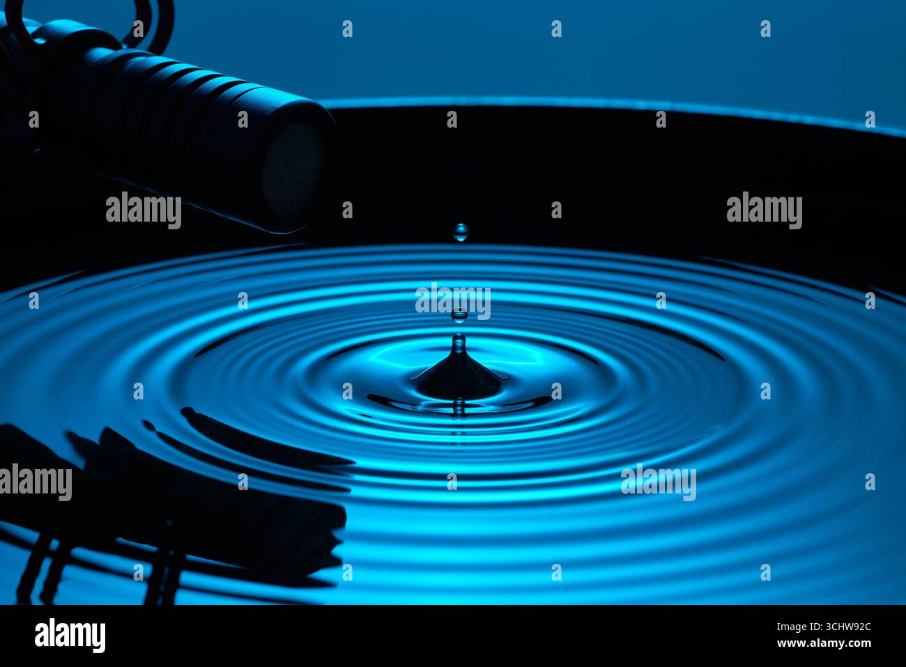 A high-speed photograph of a water droplet and ripples, being recorded ...