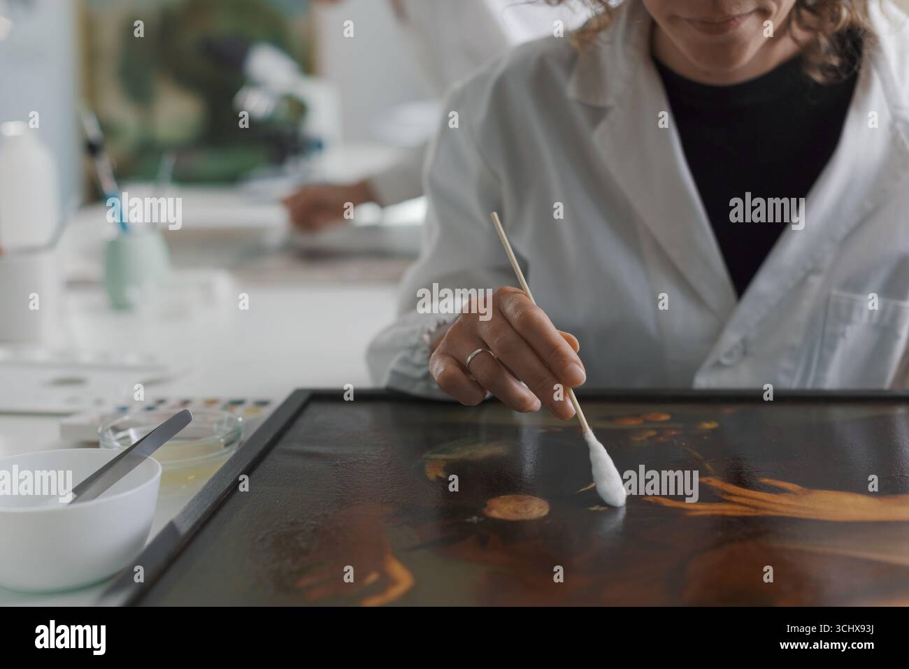 Painting conservator restoring a Caravaggio painting in the laboratory ...