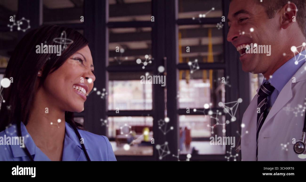 Laughing professionals in scrubs sharing eye contact in clinic with ...