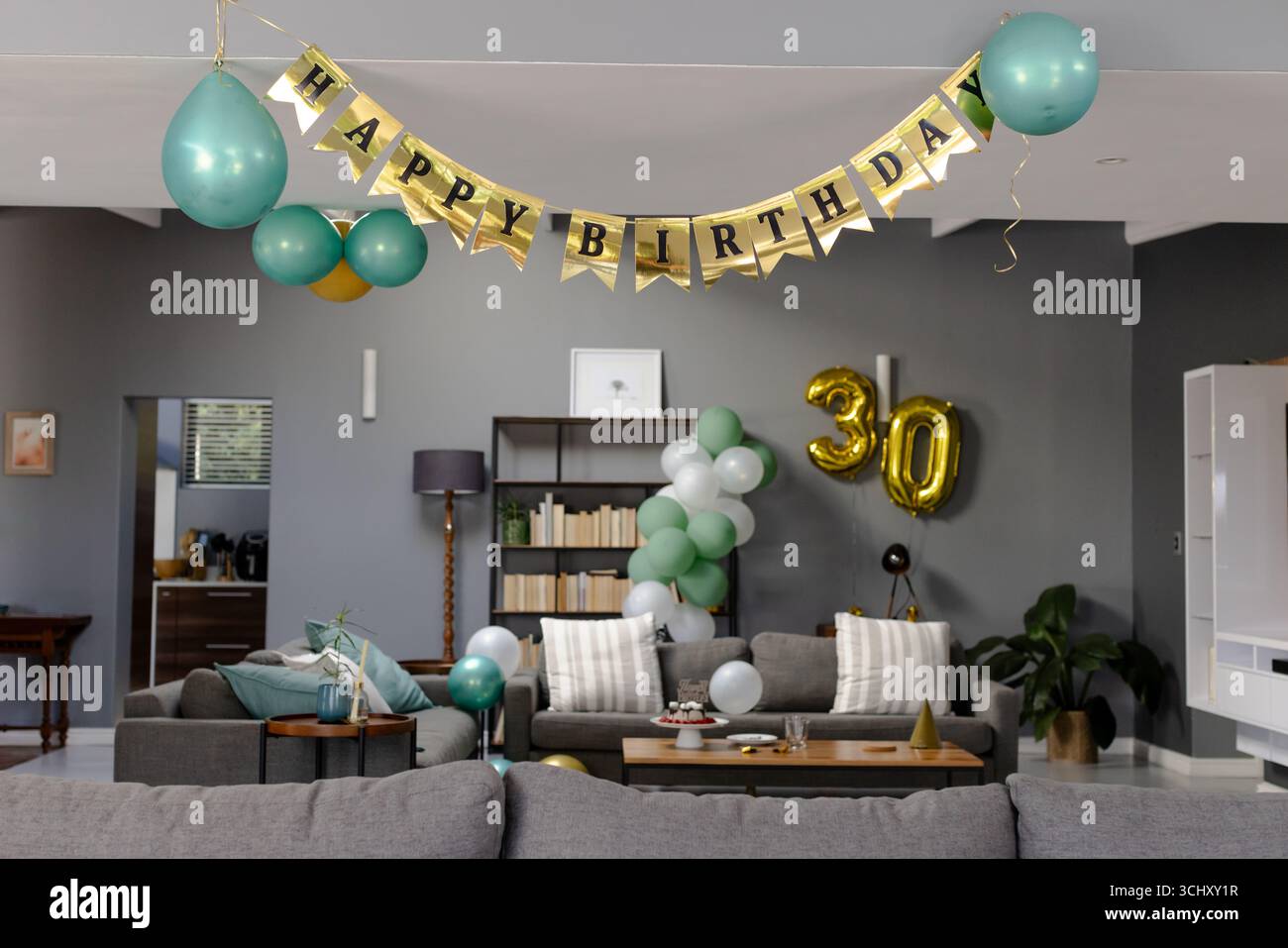 Living room decorated with balloons and banner for 30th birthday ...