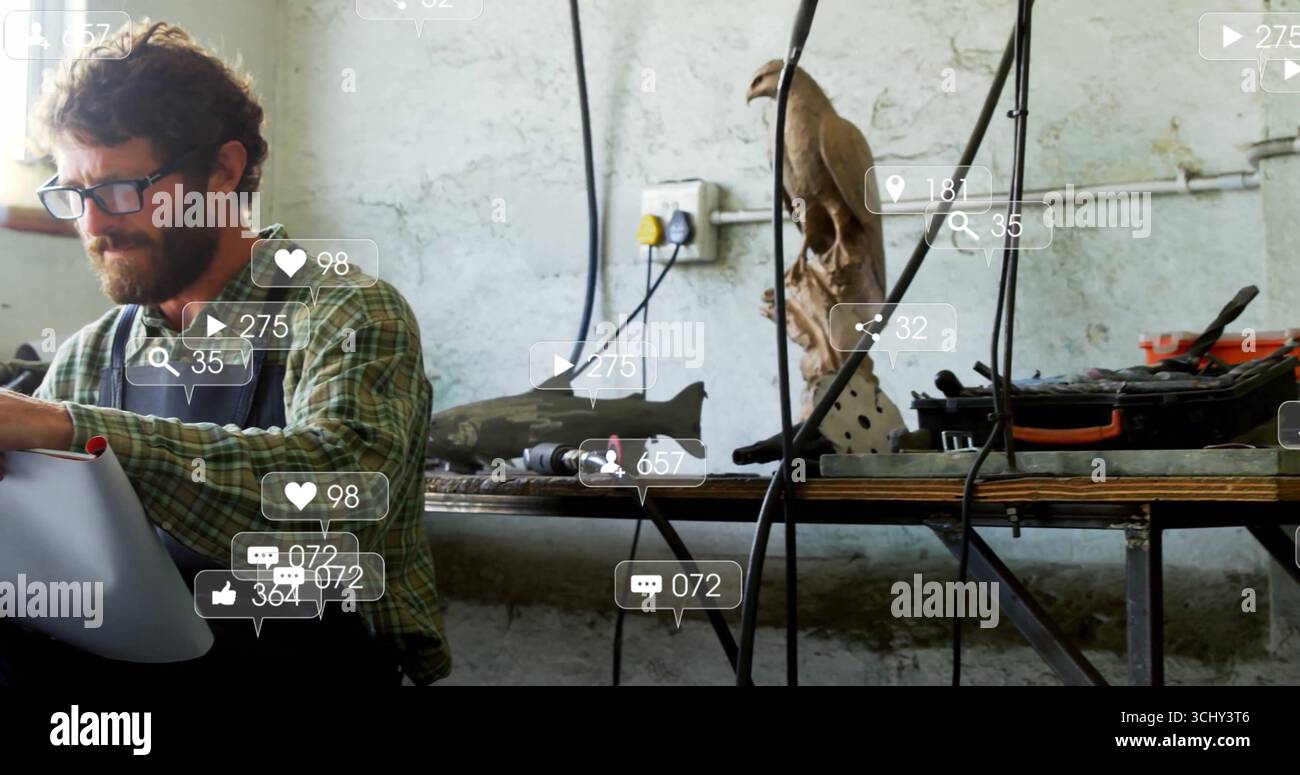 Working man wearing apron, glasses at workshop bench using drill on model plane part, copy space Stock Photo