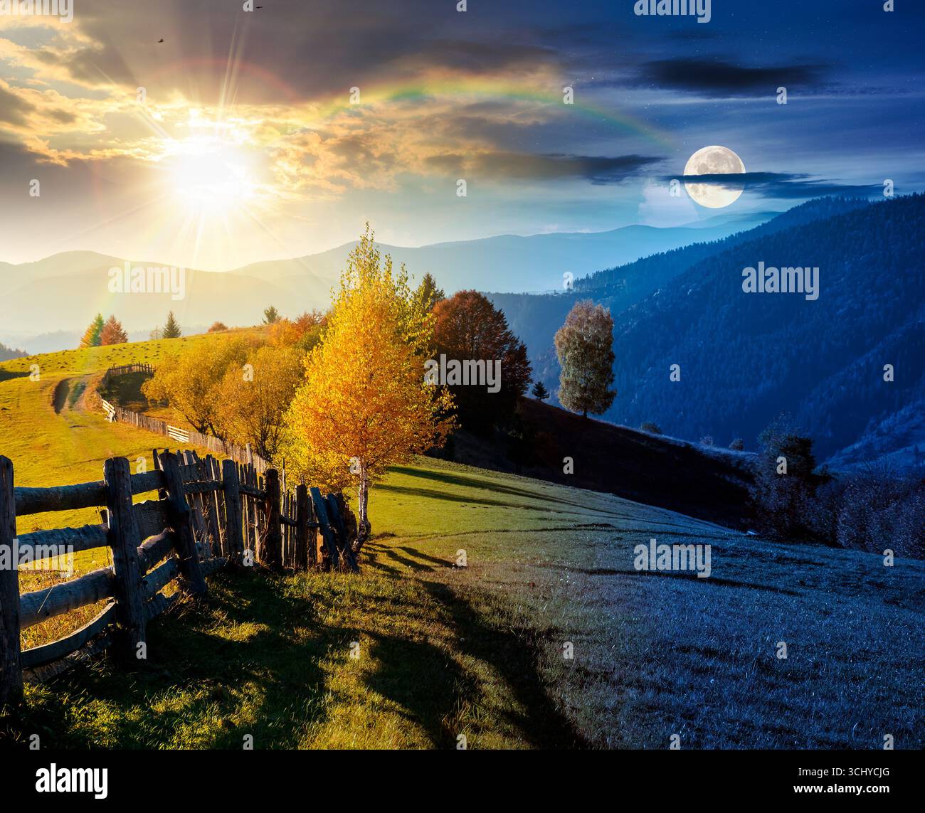 mountainous rural landscape on autumn equinox. day and night time change concept. field behind the wooden fence with sun and moon. scenery in fall sea Stock Photo