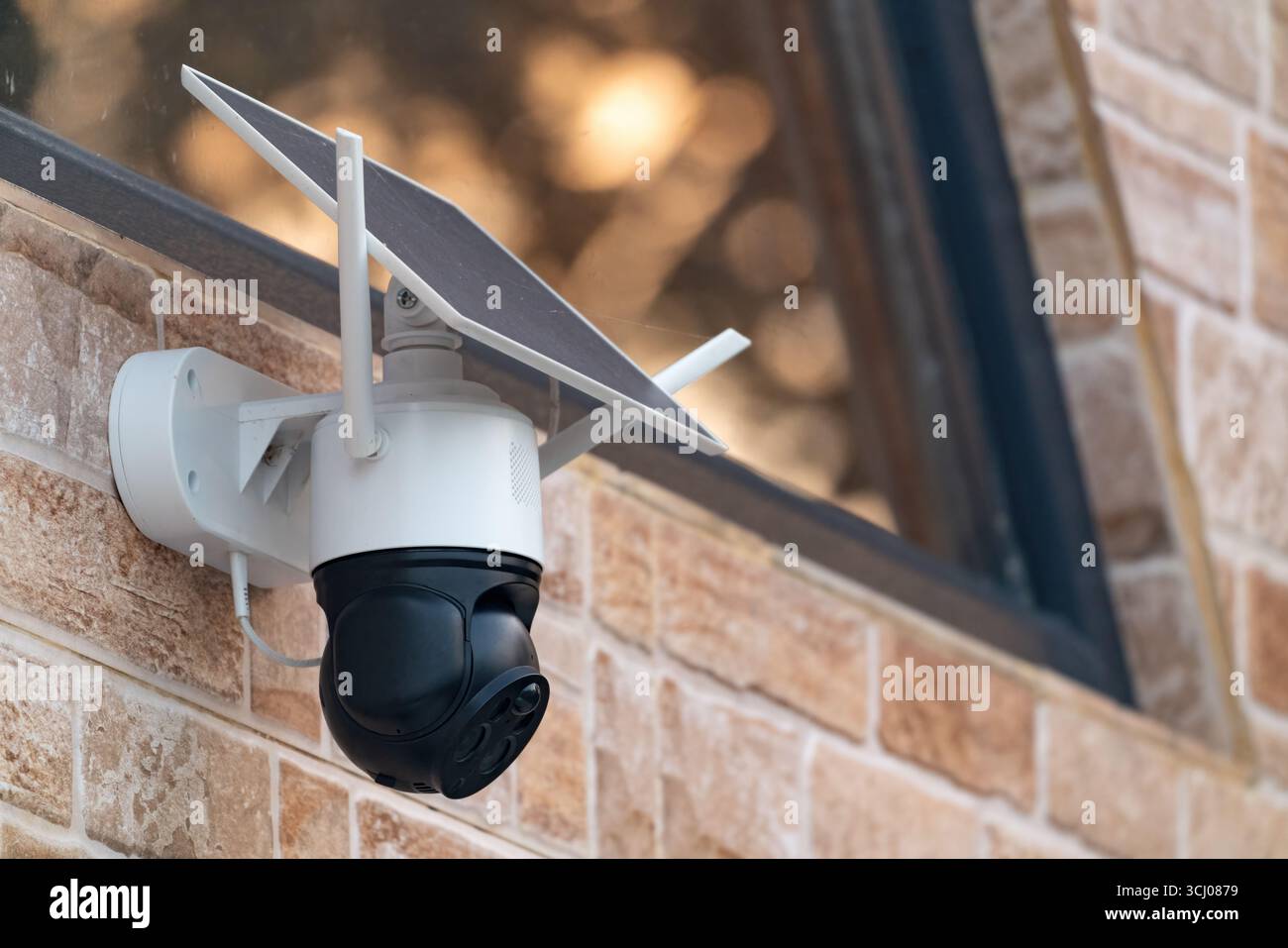 Solar powered wireless security camera on country house wall Stock Photo