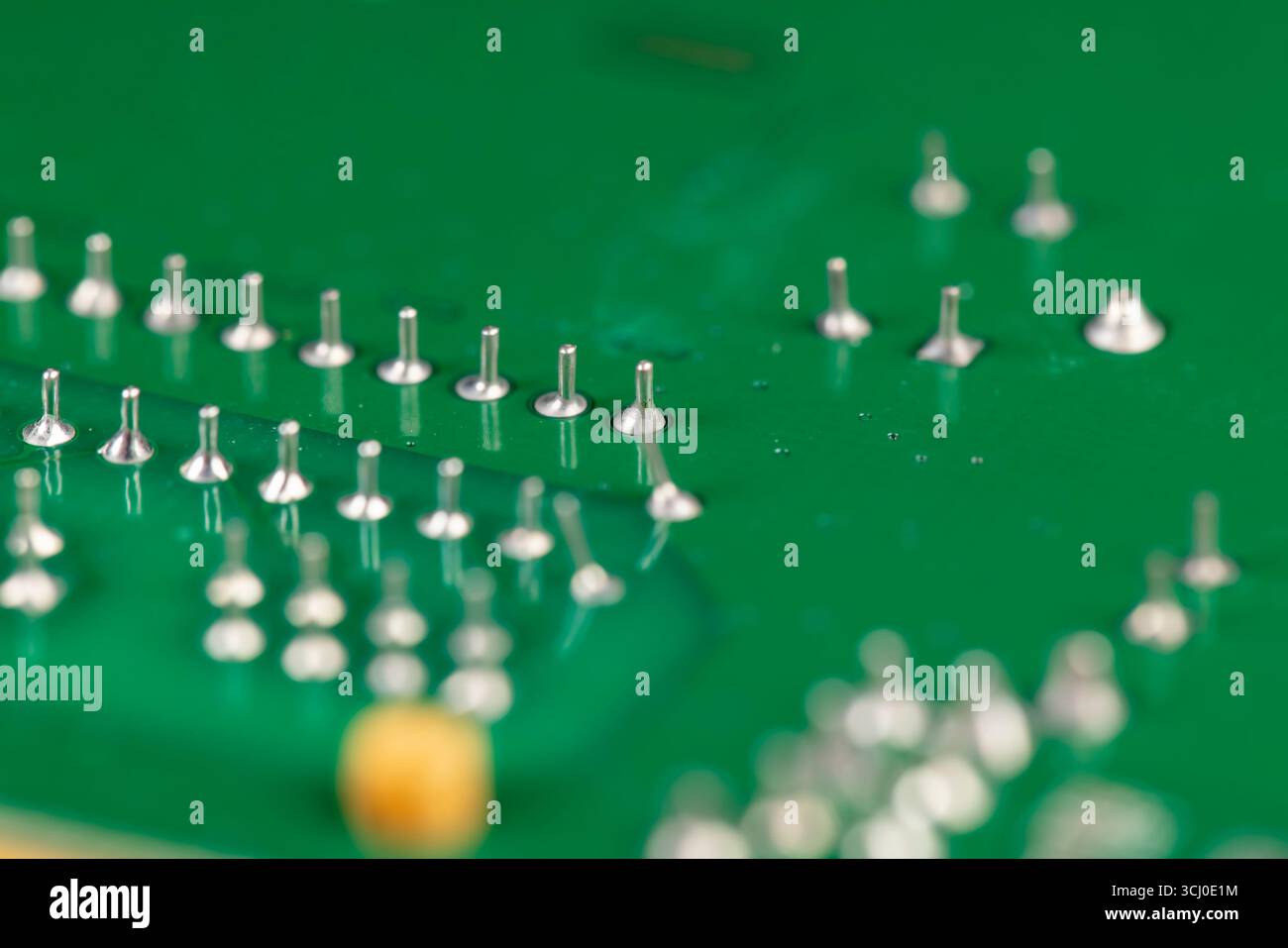 circuit board with contacts, a green printed circuit board with an electronic circuit with soldered elements Stock Photo