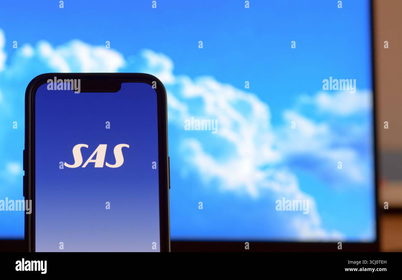 Opening Scandinavian Airlines flight booking app on a smartphone screen Stock Photo