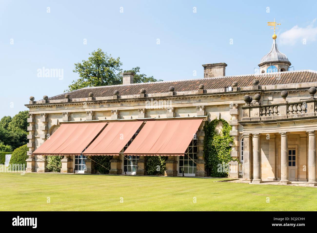 Awnings or sunshades lowered on buildings at Houghton Hall to provide shade during the hot summer of June 2025. Stock Photo