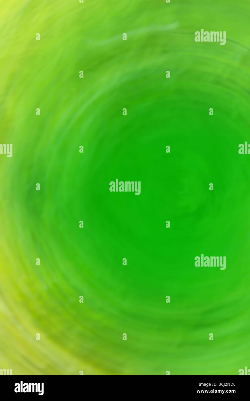 Abstract green light trail vortex. Lights moving in circular green pattern. Stock Photo