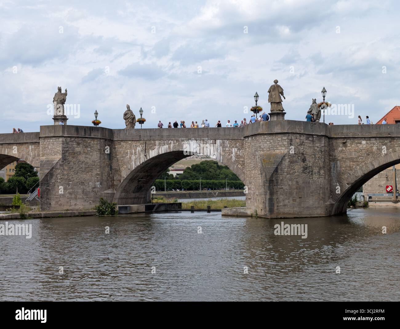 The historic bridge in Würzburg over the Main River is a pedestrian bridge famous for 12 statues and oldest bridge on the Main River Stock Photo