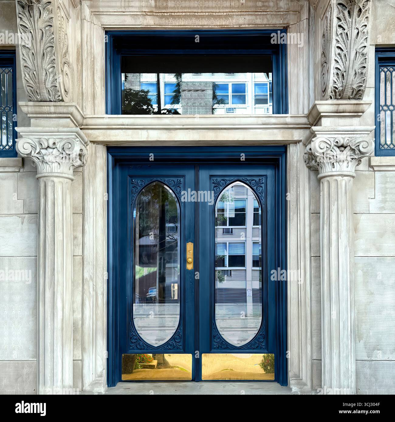 Grand arched double blue doors framed by Corinthian columns and ornate stone detailing on a historic Chicago building. - Smartphone Captured Stock Image
