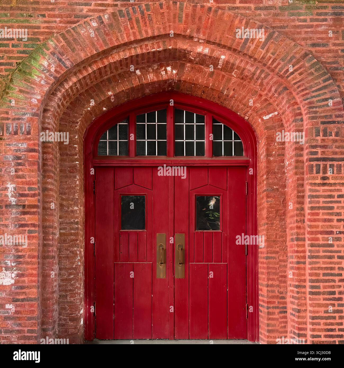 Gothic arched red double doors with small windows set in a historic brick church facade in Chicago. - Smartphone Captured Stock Image