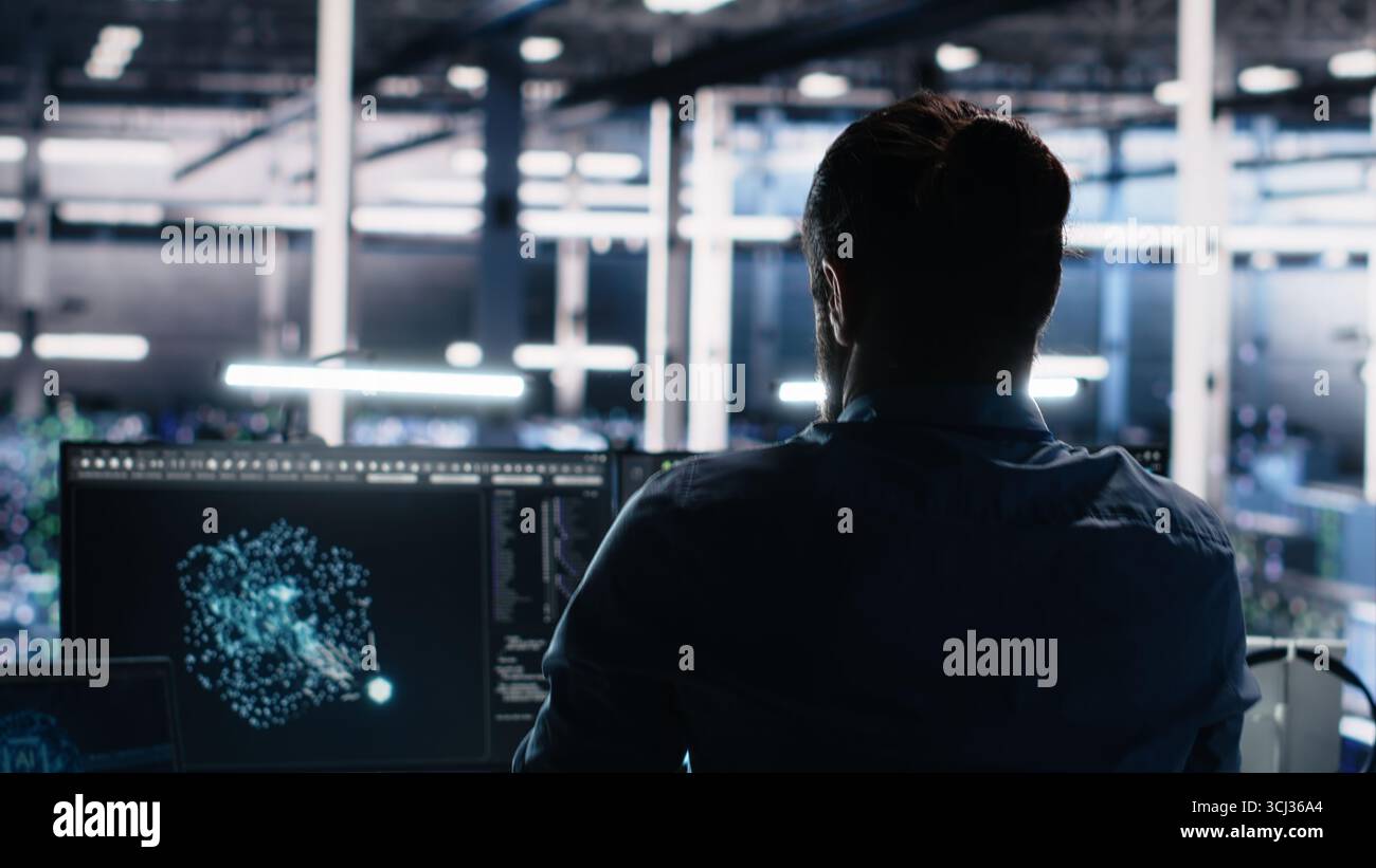 Server room technician stretching sore back while using AI at desk. Fatigued IT expert in data center relaxing strained muscles, feeling backache while using artificial intelligence, camera A Stock Photo