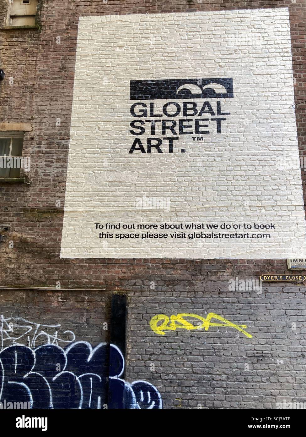 Global Street Art, Europe's leading hand-painted advertising company, advertising exterior wall space, Dyer's Close Cowgate, Edinburgh Scotland - Smartphone Captured Stock Image