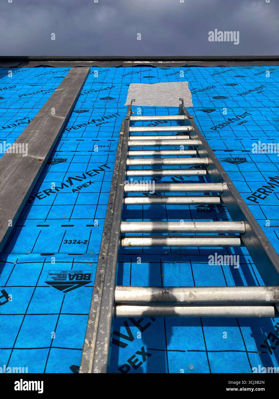 Communal Roof repairs underway on an Edinburgh tenement, installing a breathable waterproof membrane underlay and re-slating works Stock Photo