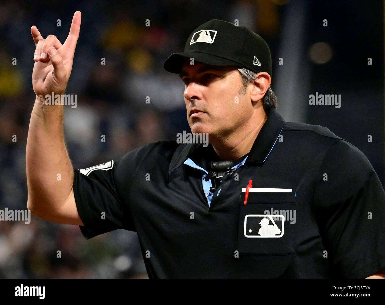 Home plate umpire Mark Ripperger signal as he returns from the mound ...