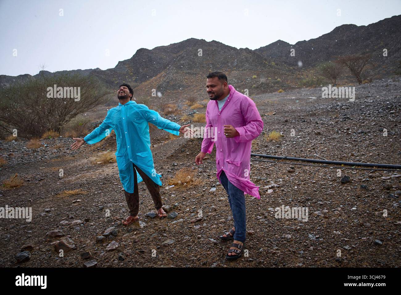 People stand in the rain as they chase rain showers in Fujairah, United ...