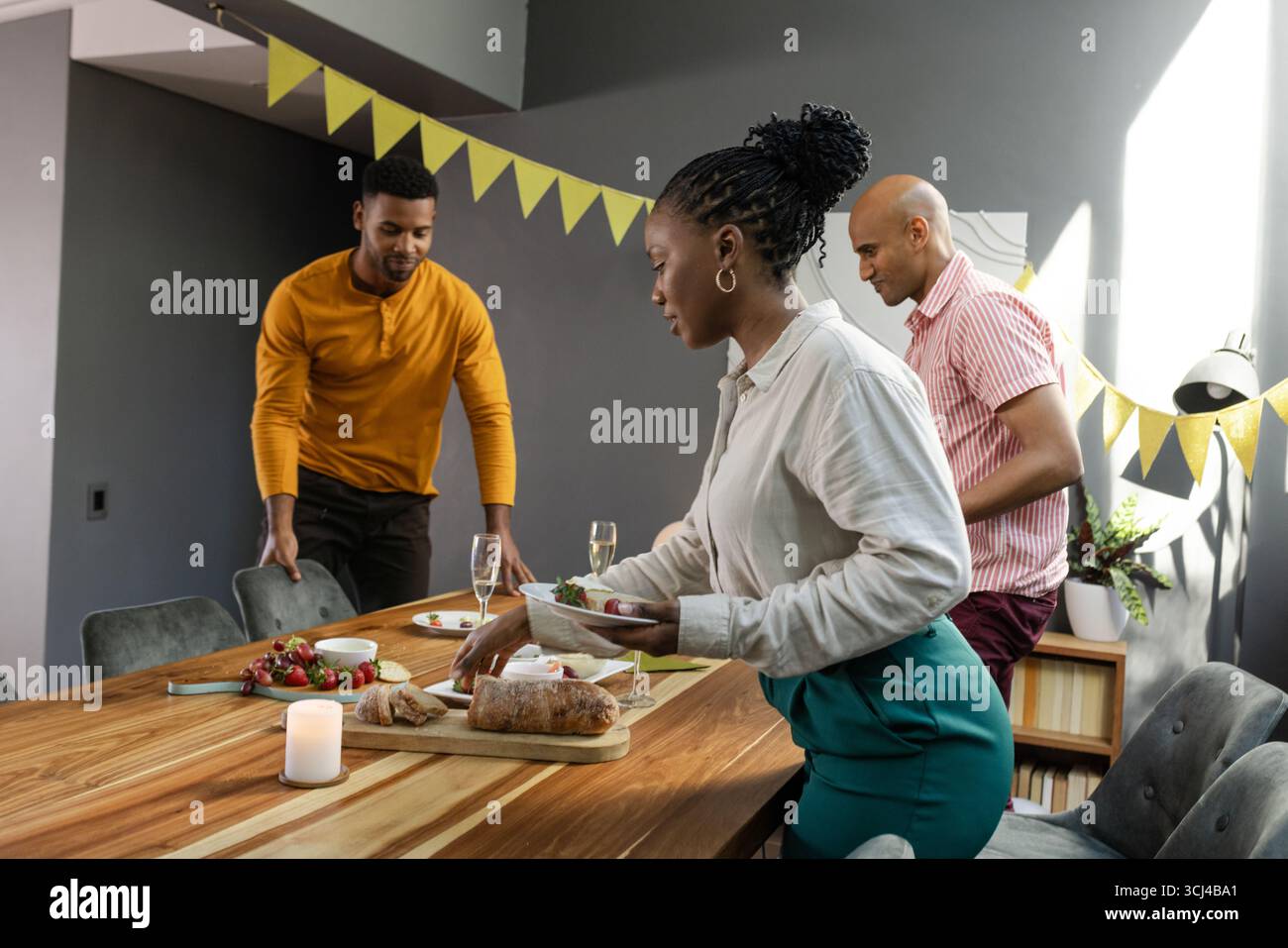 Friends preparing festive table hi-res stock photography and images - Alamy