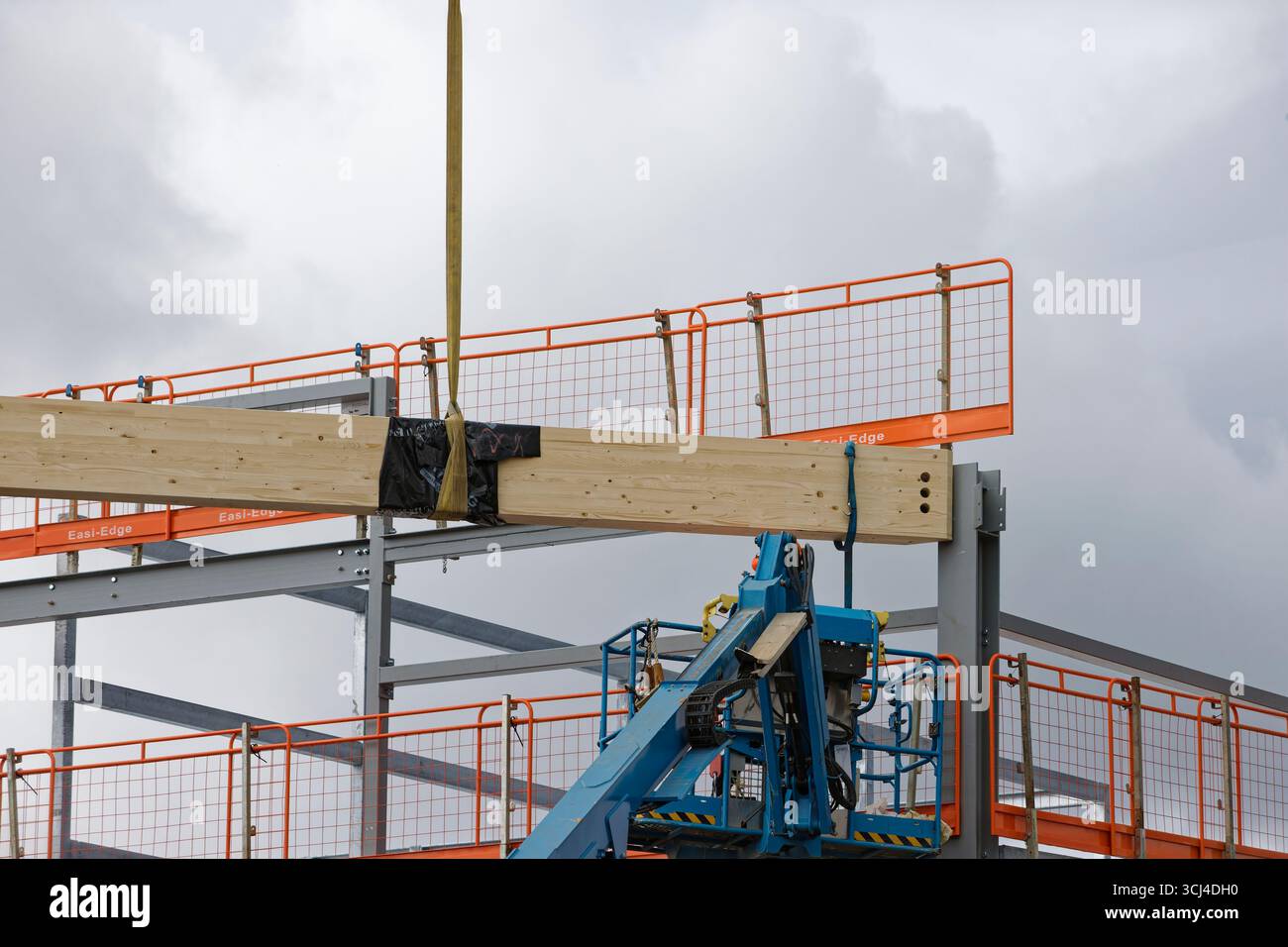 Workman Manchester Laminated wooden beam attached to yellow lifting sling hi-res stock ...