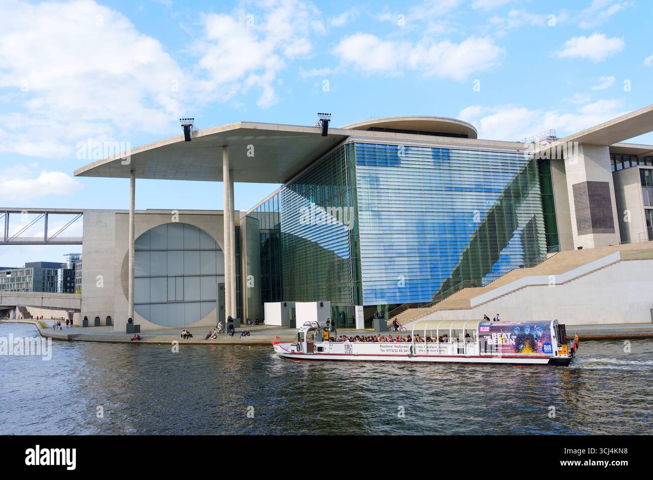 Berlin, Germany - August 20, 2025: Modern architectural structure of Marie-Elisabeth-Lueders-Haus with boat tours on the Spree River. Stock Photo